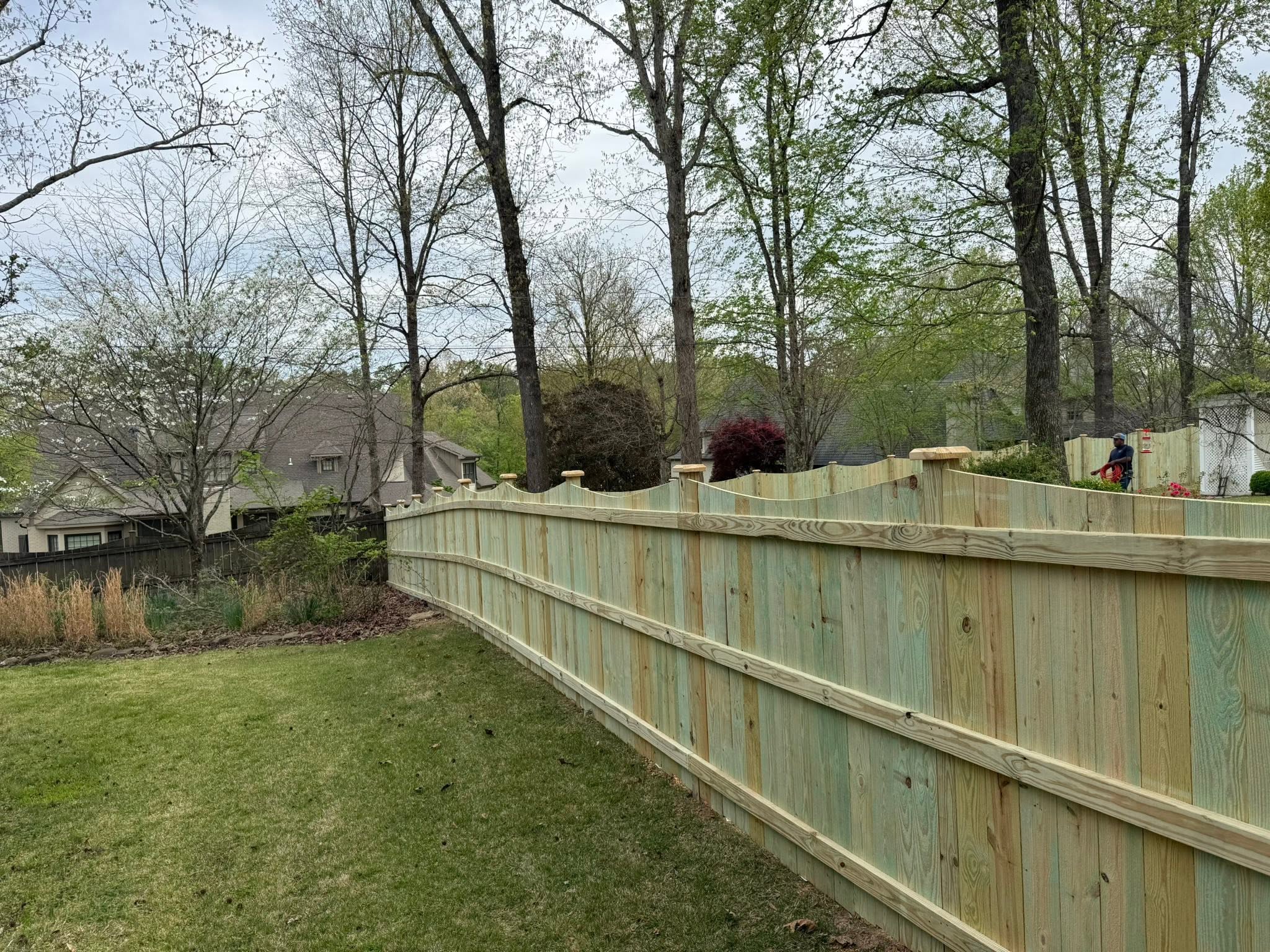 Arched scalloped wood privacy fence line by Vaughn Fence in Muscle Shoals, AL
