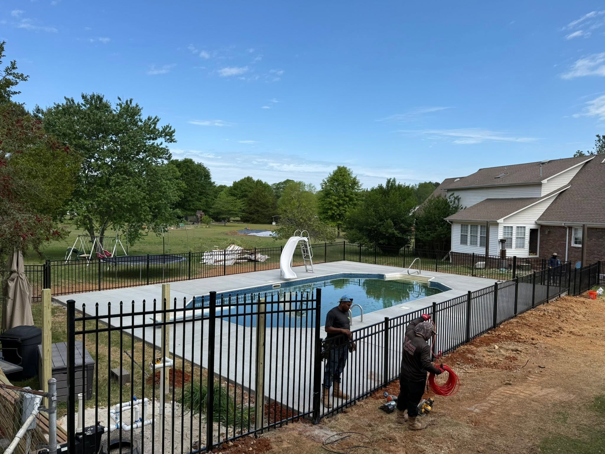 Black ornamental metal pool safety fence installation near Muscle Shoals, AL