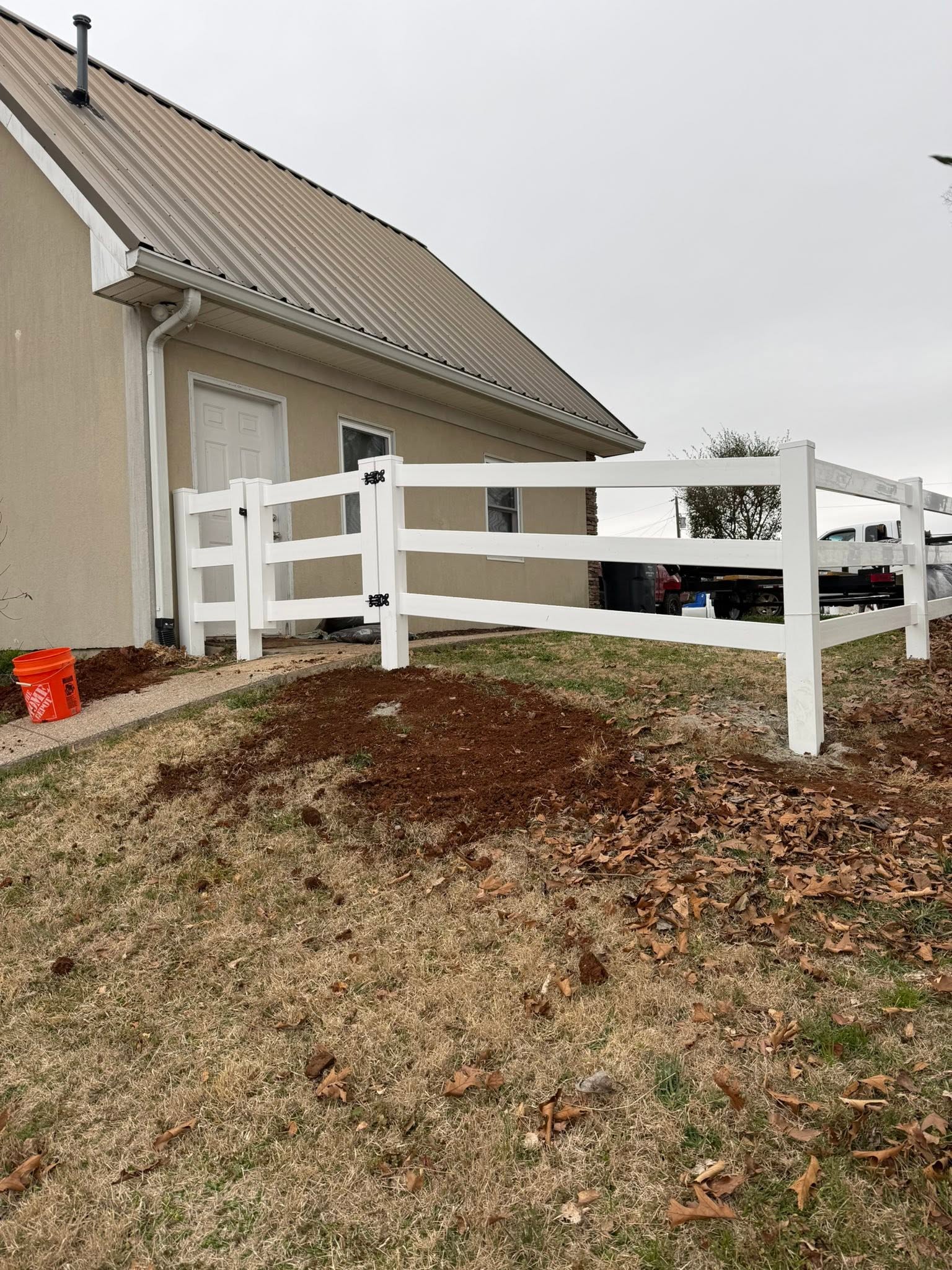 White vinyl three-rail ranch fence and gate installation in Northern Alabama
