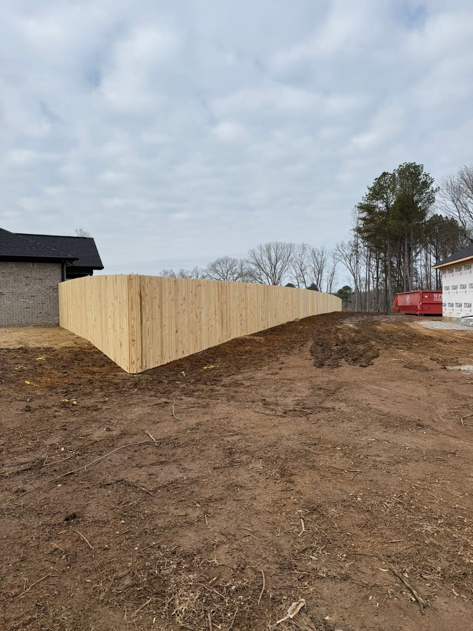 New-construction wood privacy fence perimeter in Muscle Shoals, AL