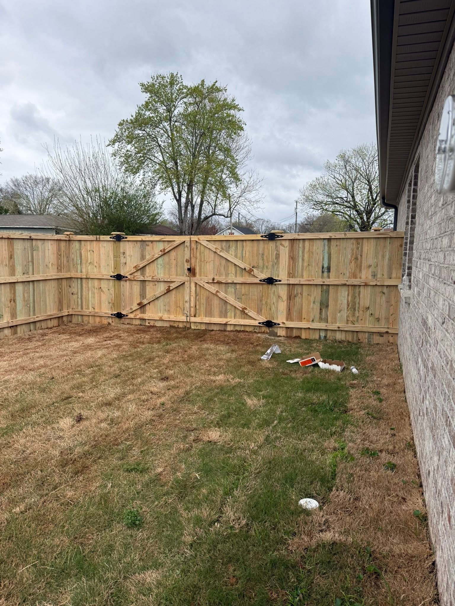Wood privacy fence double gate with black strap hinges in Muscle Shoals, AL