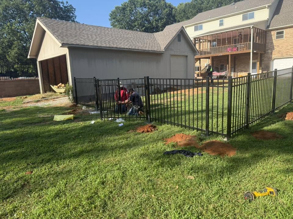 Vaughn Fence crew installing black ornamental metal fencing in Northern Alabama